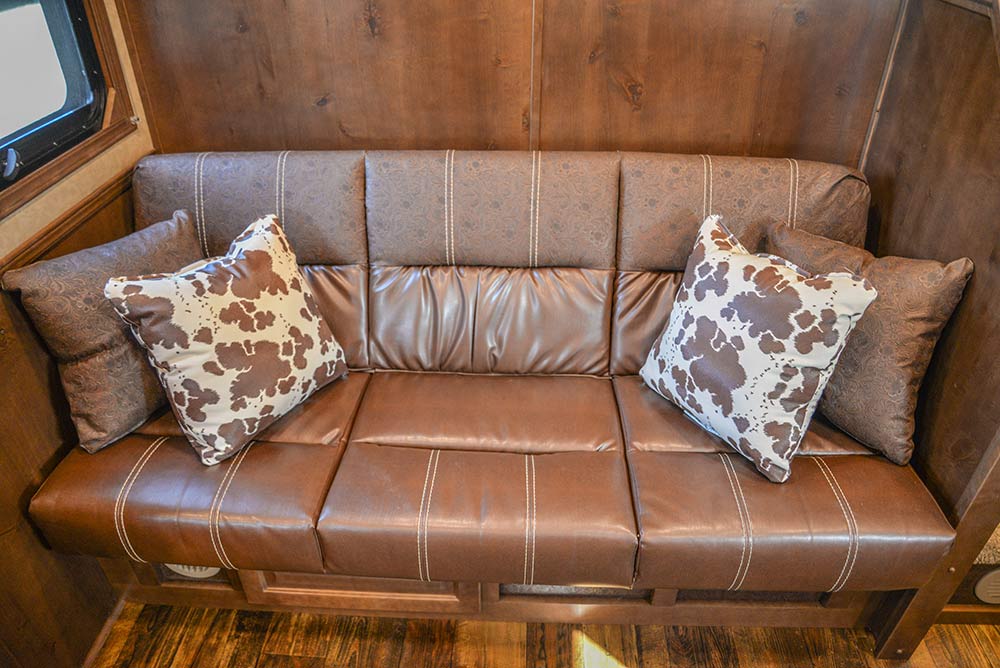 Sofa in a BH8X13SR Bighorn Edition Horse Trailer | Lakota Trailers